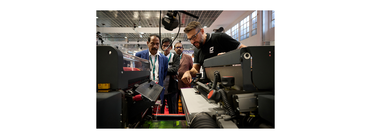 A press operator showcases the machine to a customer at Labelexpo Europe 2023.  