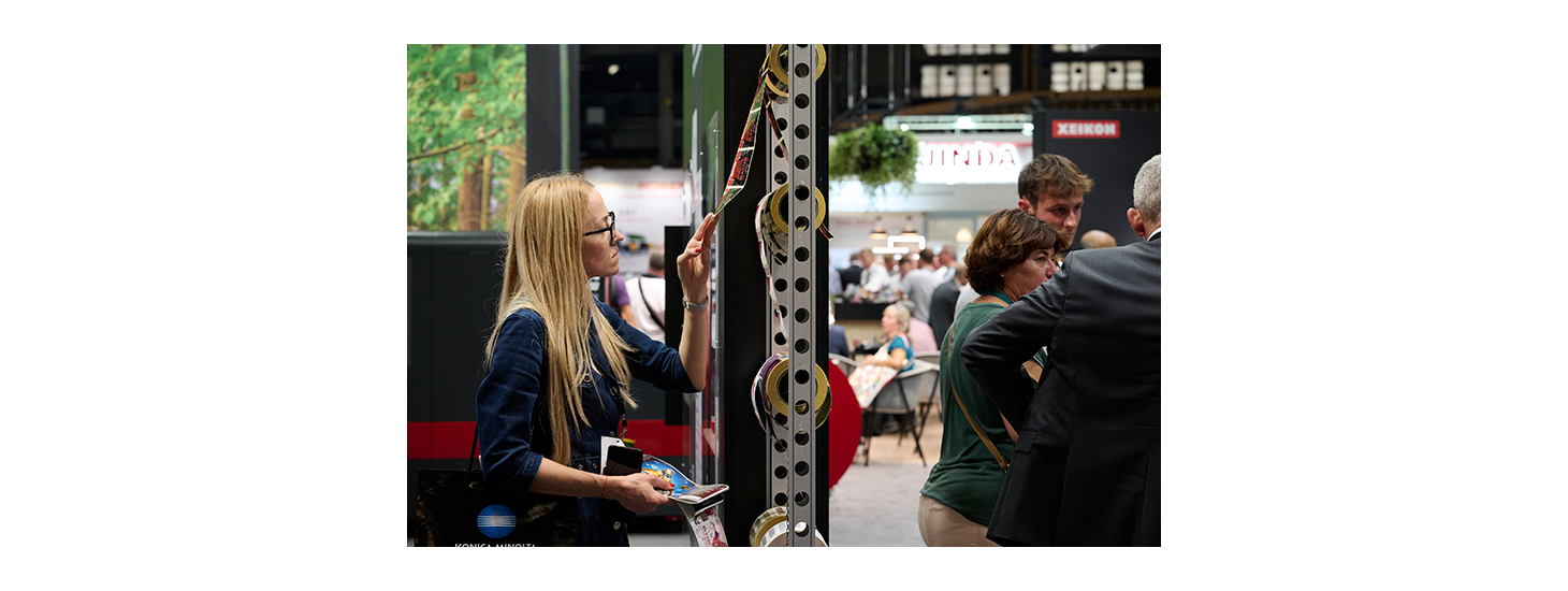 A woman at Labelexpo Europe 2023 examines materials.